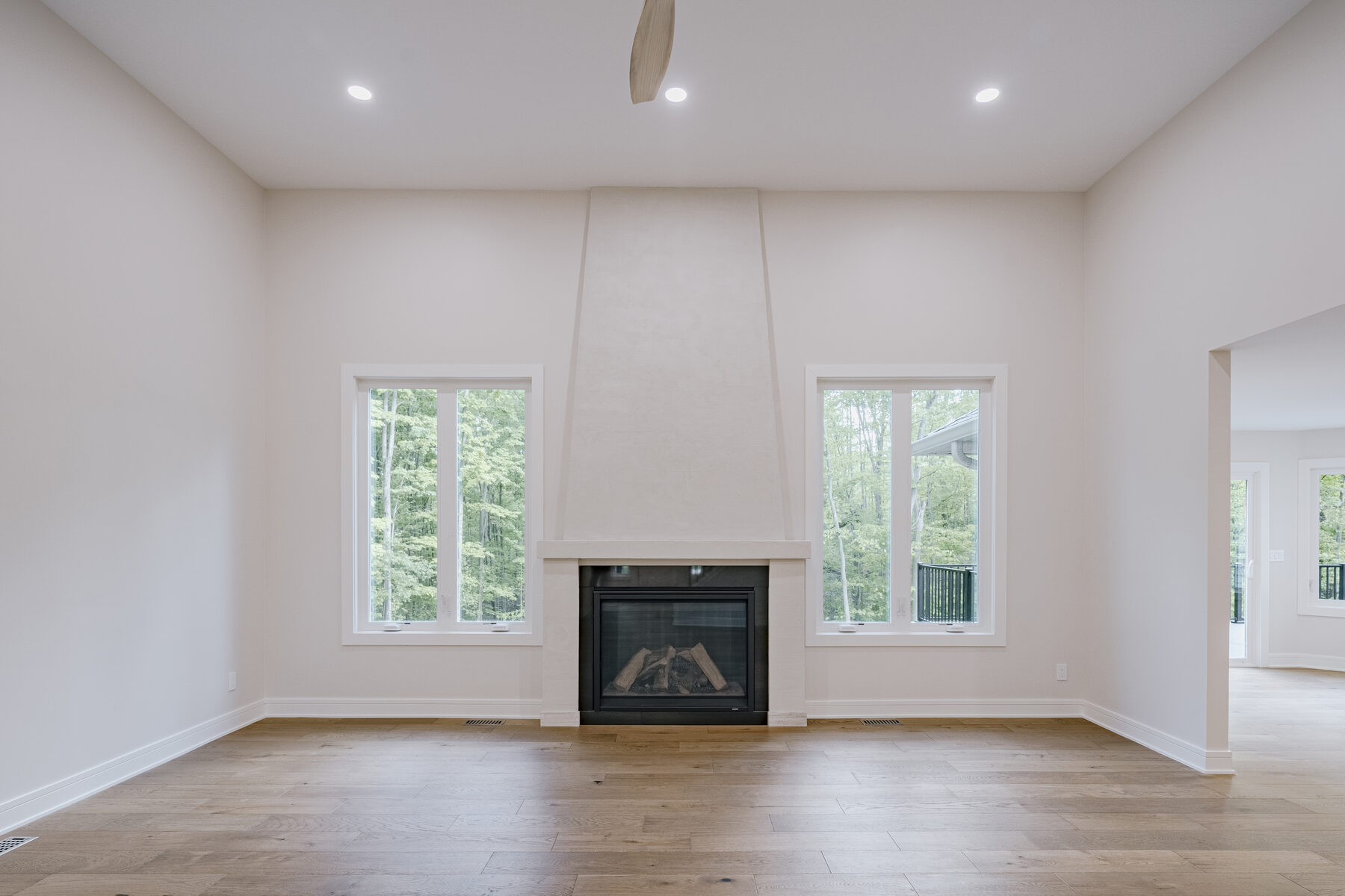 Living room with fireplace and oversized windows