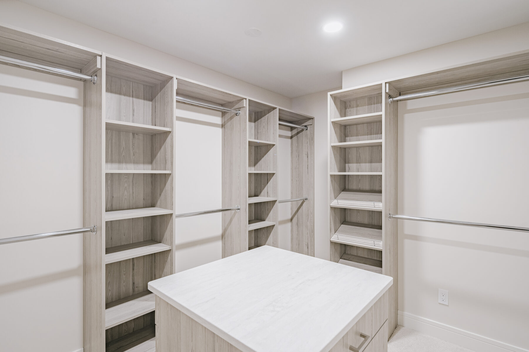 Primary walk-in closet with custom built-ins