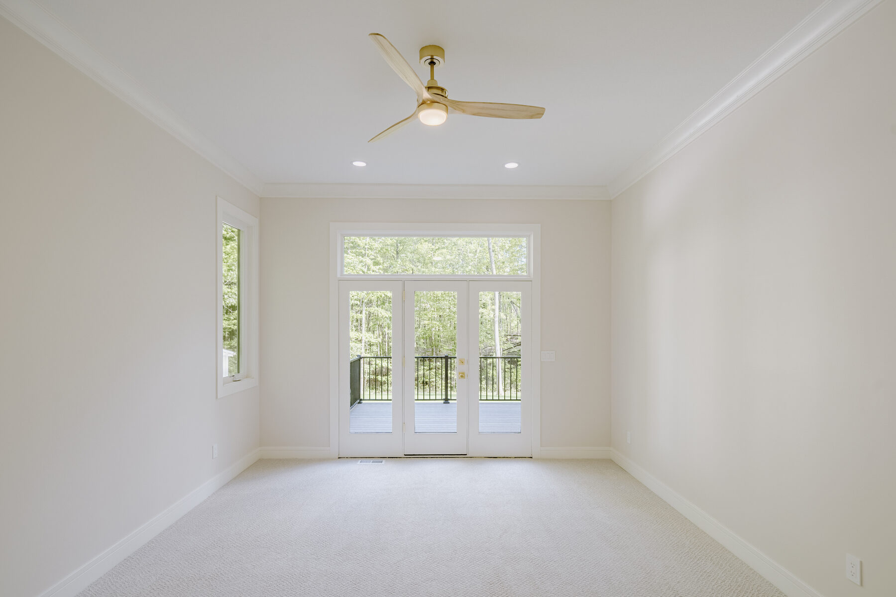 Primary bedroom with French doors to the deck