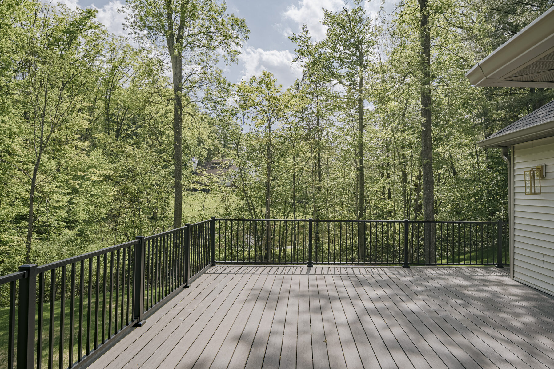 Back deck overlooking wooded acreage